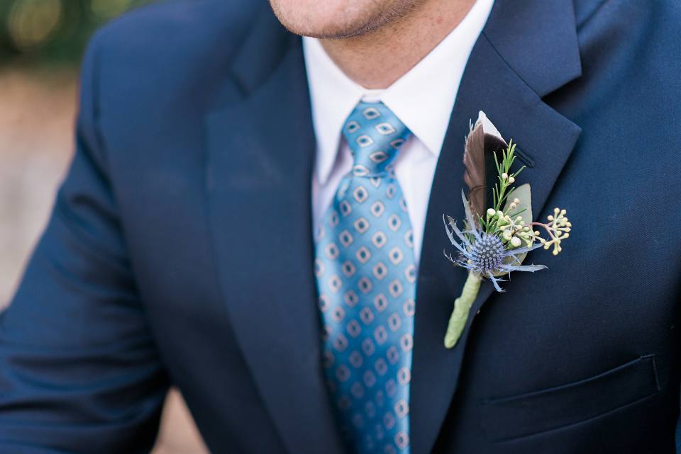 Groom boutonniere with duck feather