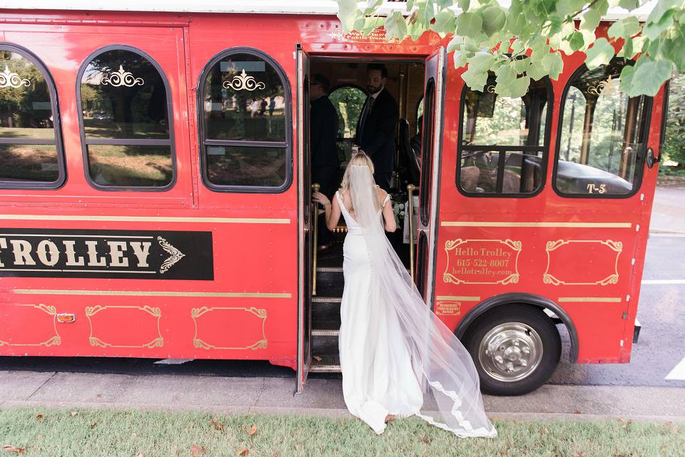 Bride getting into red trolley Nashville TN