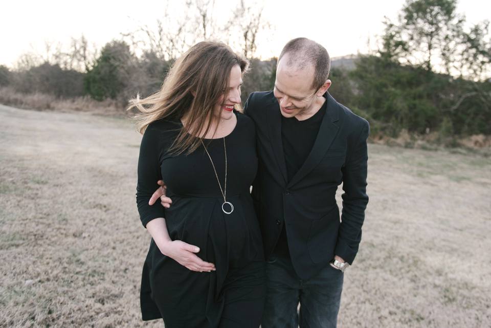couple walking together maternity session outdoors in winter nashville