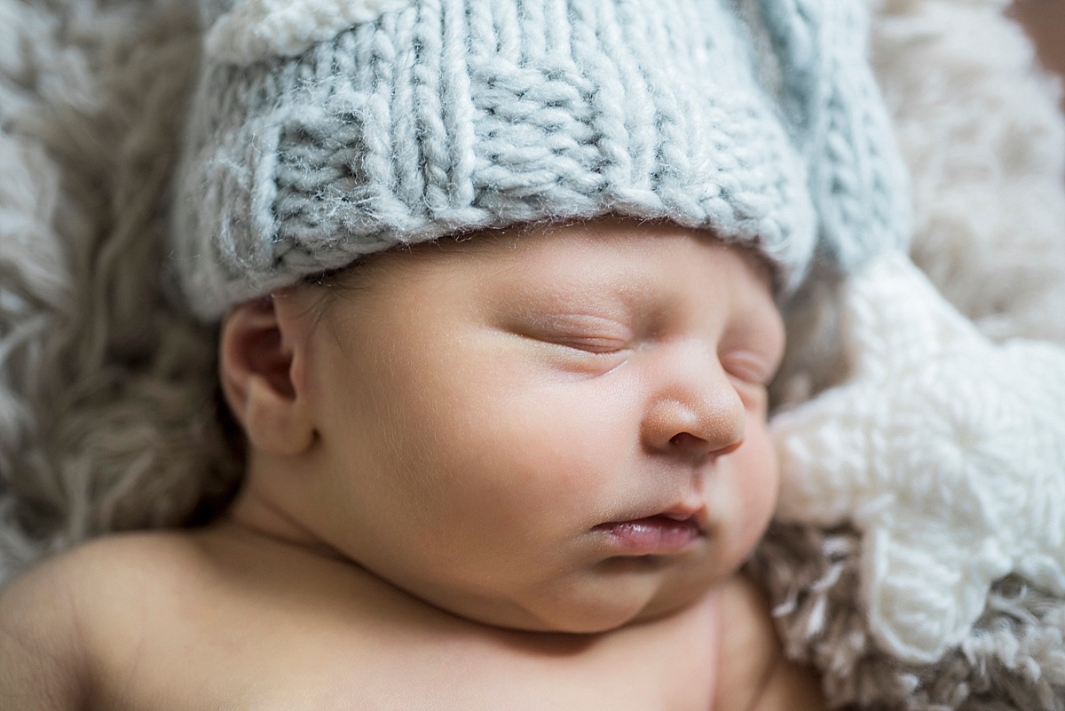 newborn baby in blue hat