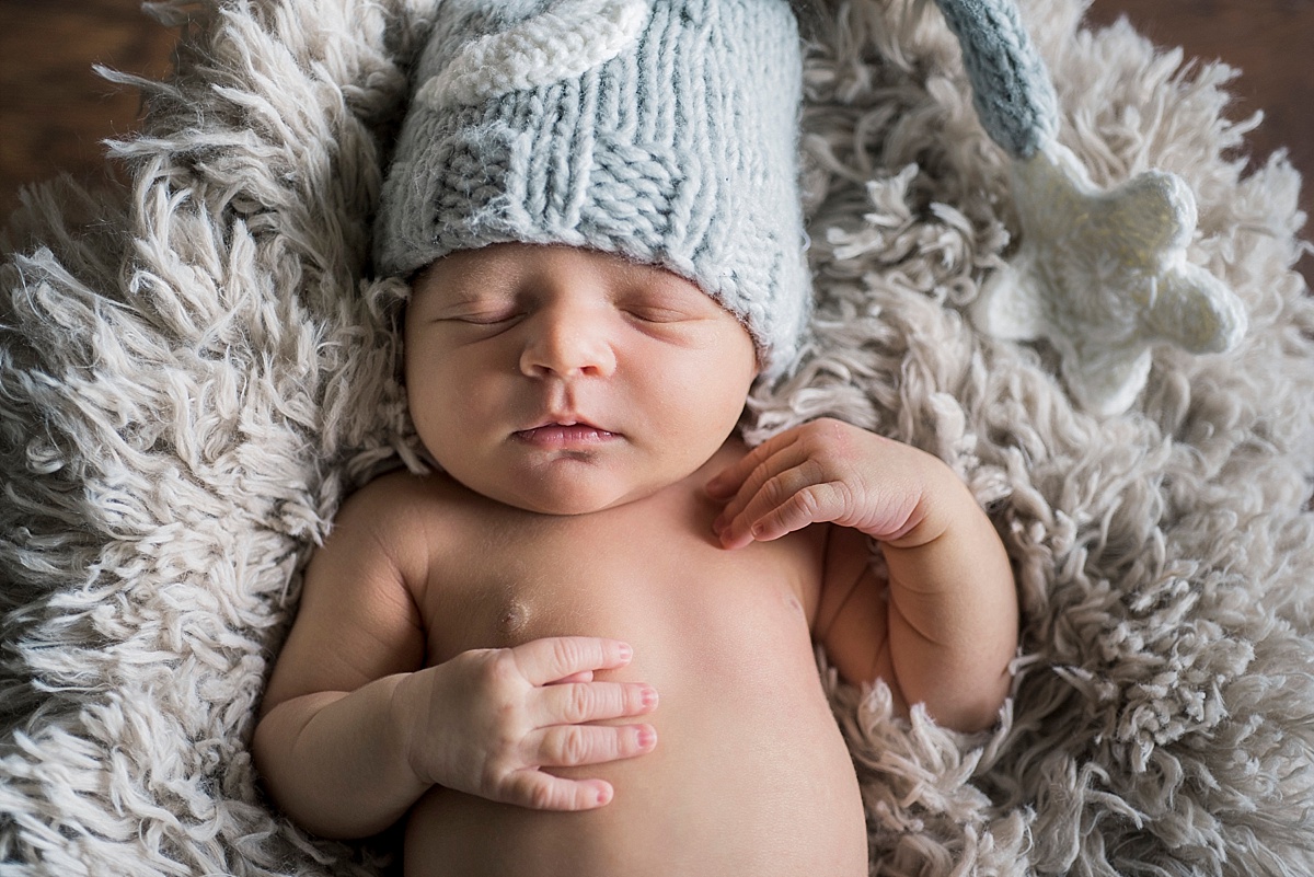 newborn baby wearing blue knit hat