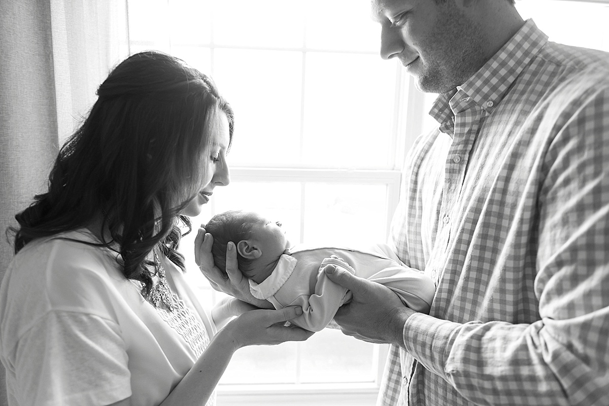 newborn baby with mom and dad black and white