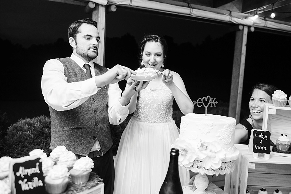 Cake cutting bride and groom wedding reception black and white