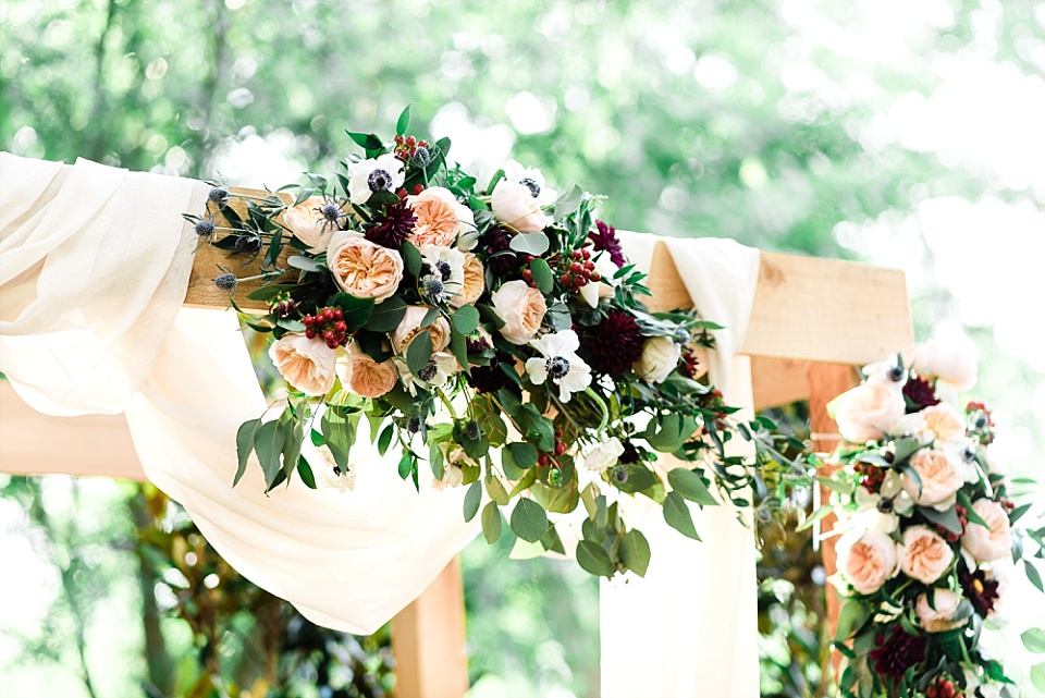 Outdoor wedding chuppah flowers drapery Enchanted Florist Nashville