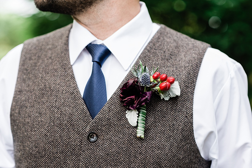 Groom boutonniere with red berries Enchanted Florist Nashville