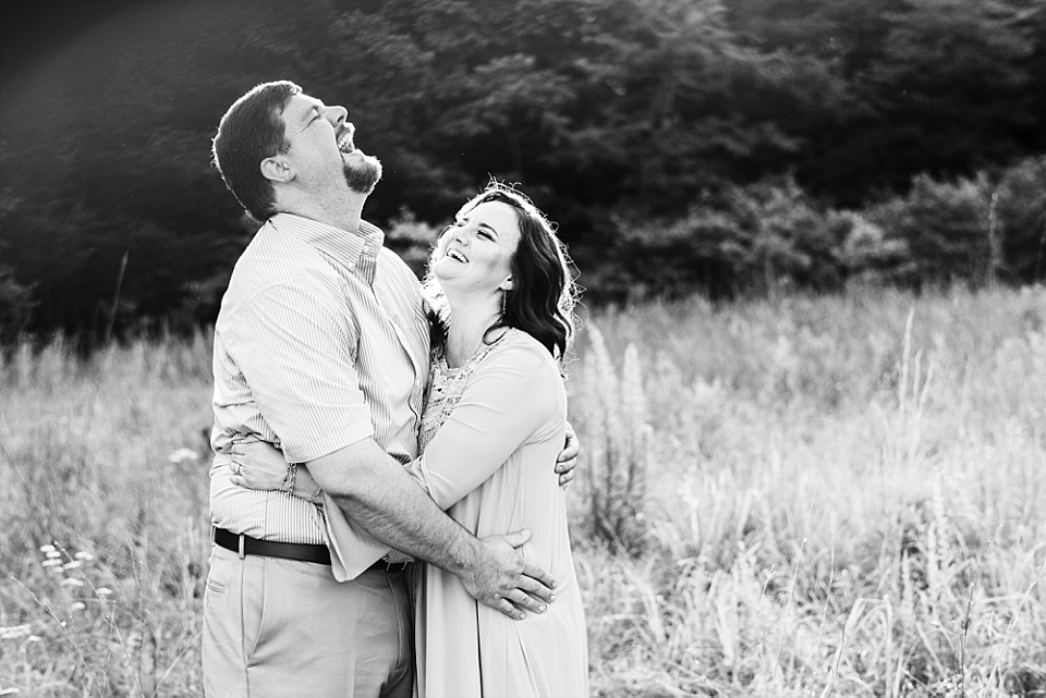 couple laughing black and white engagement session