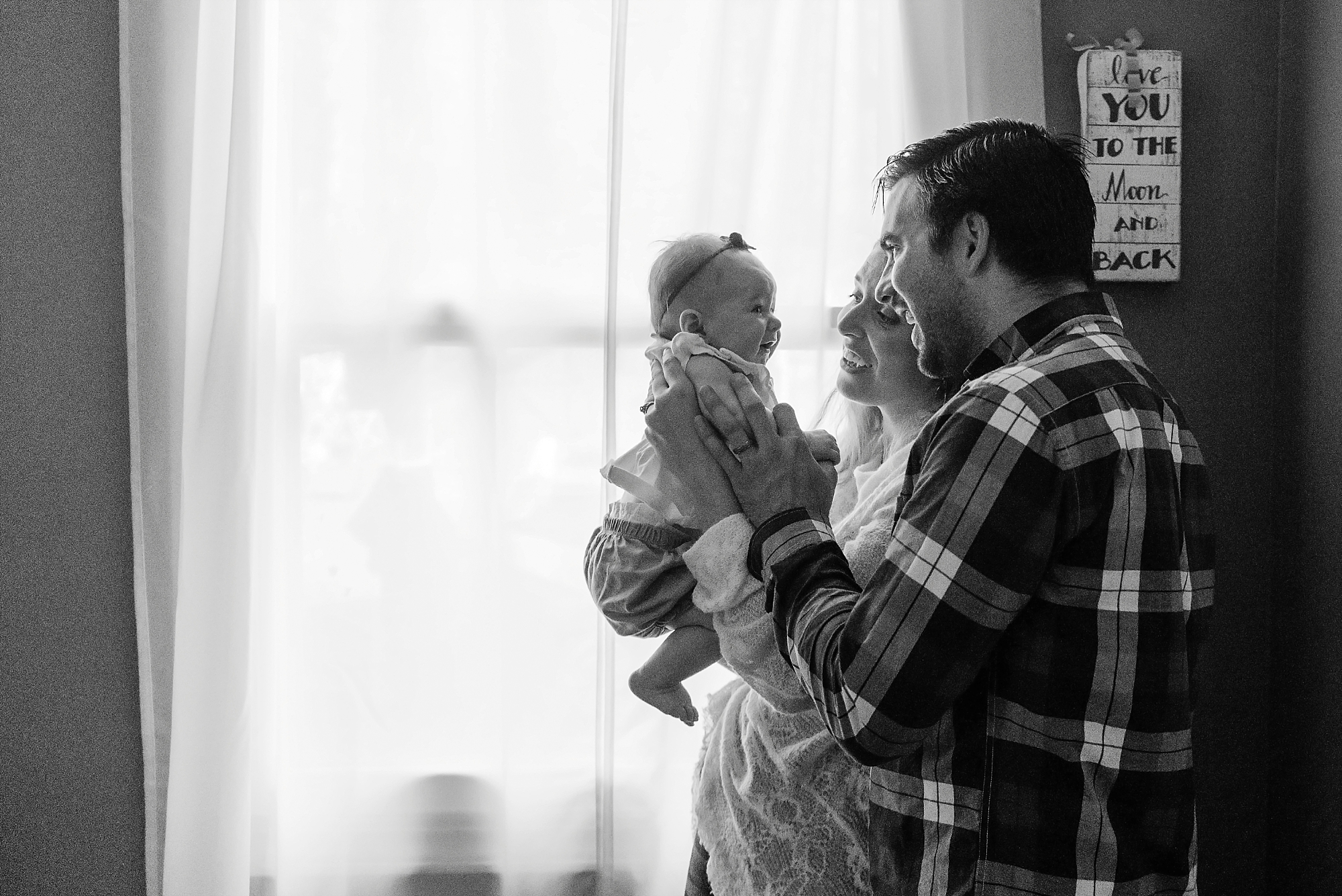 dad and mom with baby indoor family session Nashville