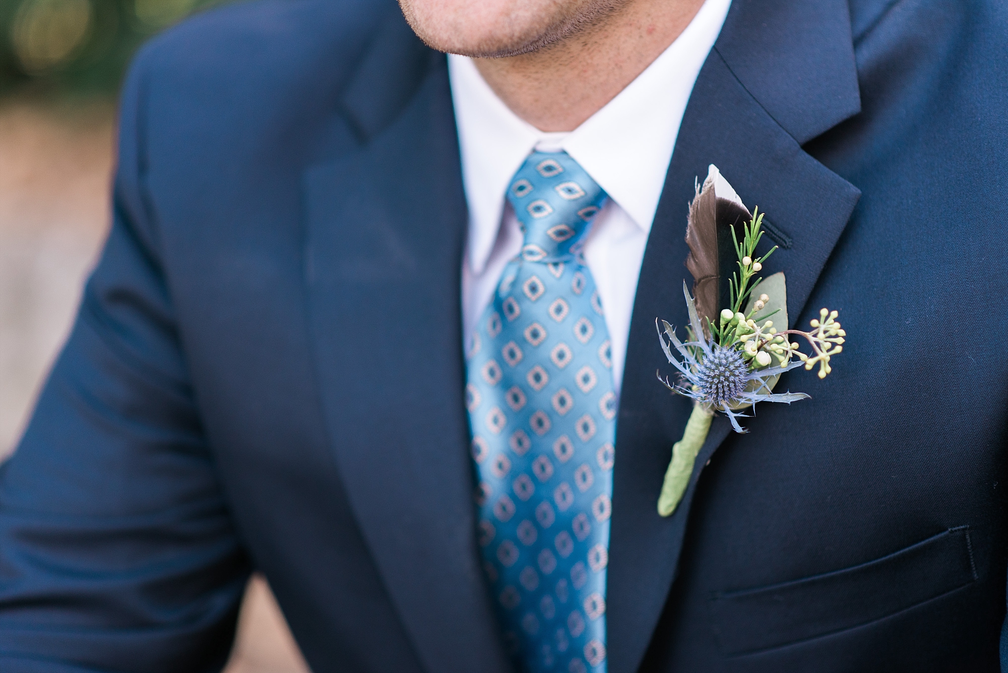 groom boutonniere with duck feather