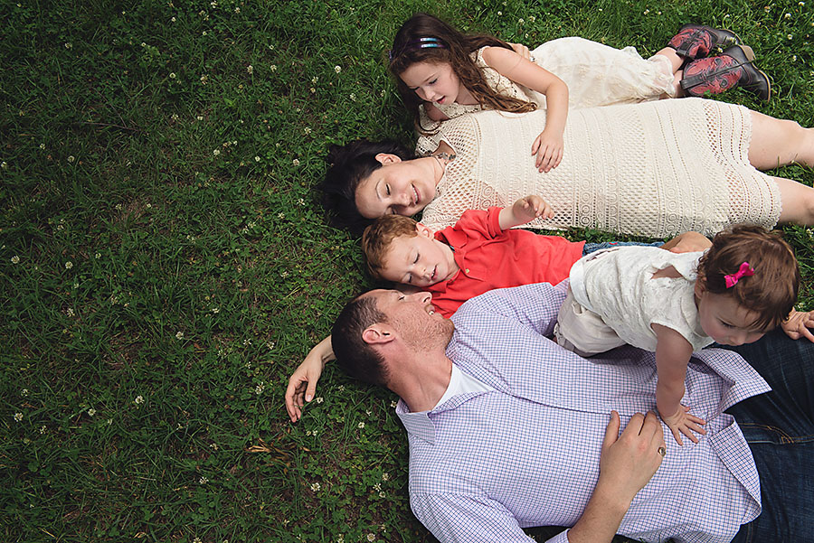 Coleman family plays in the grass at Bicentennial Park during a family photography session in Nashville, TN