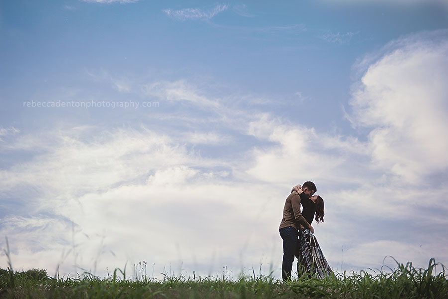 Couple embraces on a hill at sunset during engagement photos in Nashville.
