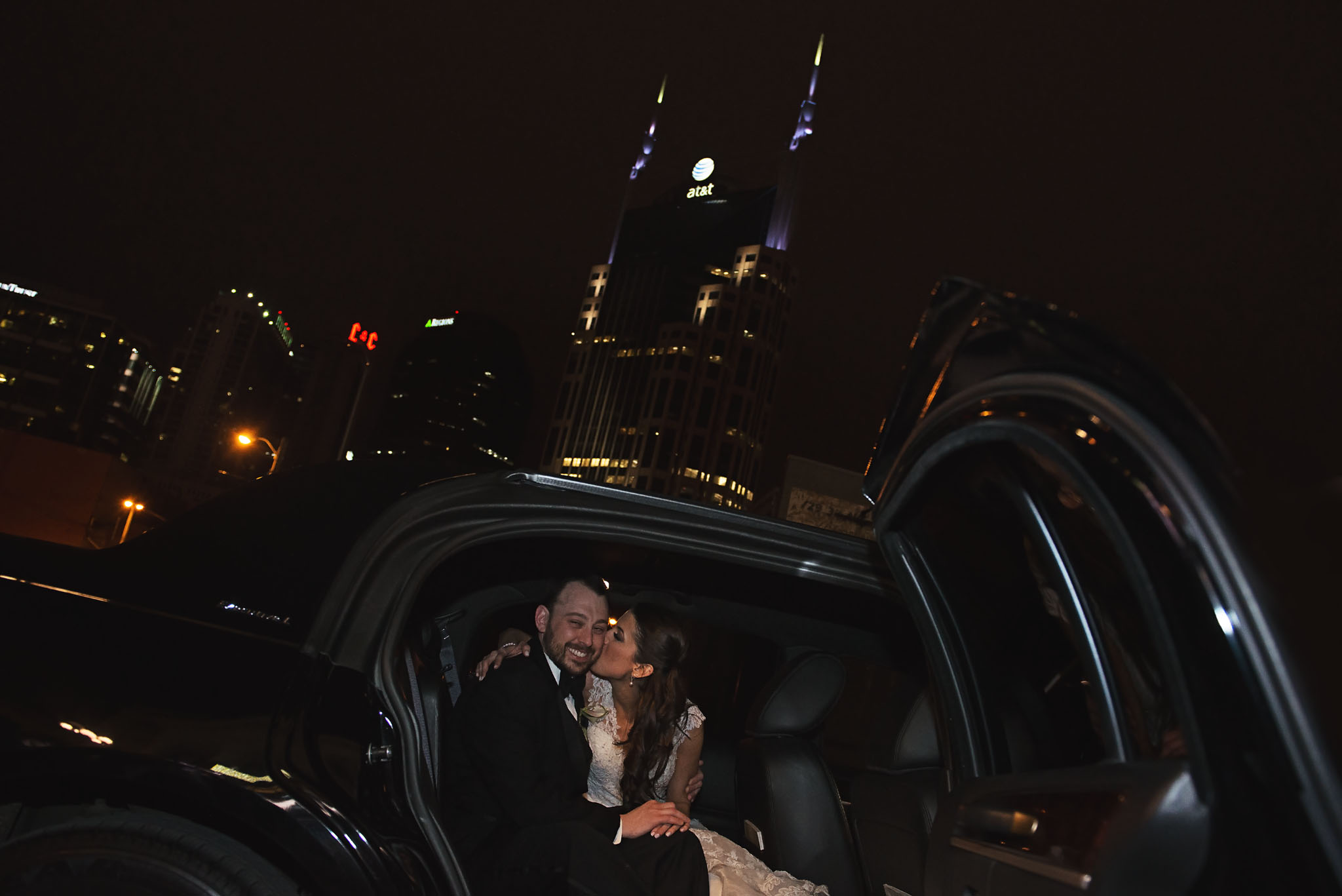Wedding couple in limousine with Batman building in Nashville