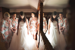 Bride reflected in mirror with bridesmaids