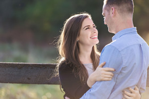 Engaged couple in field laughing