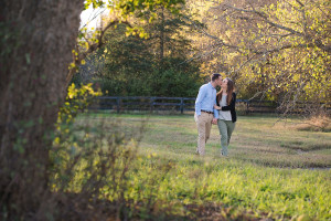Engaged couple walking in field