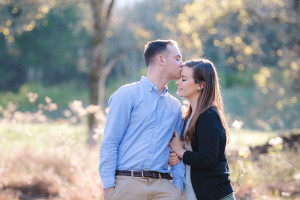 Engaged couple kissing in field Nashville