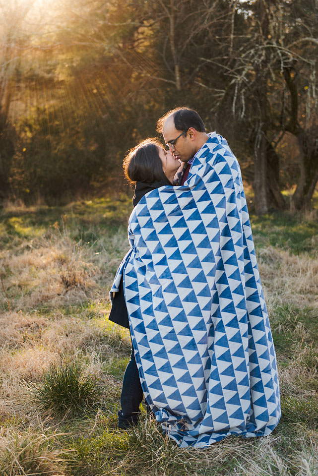 couple wrapped in blue and white blanket