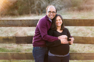 couple in front of fence maternity photography
