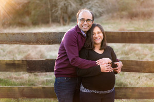 couple by fence maternity picture