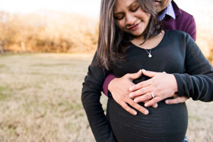 couple in field maternity photograph