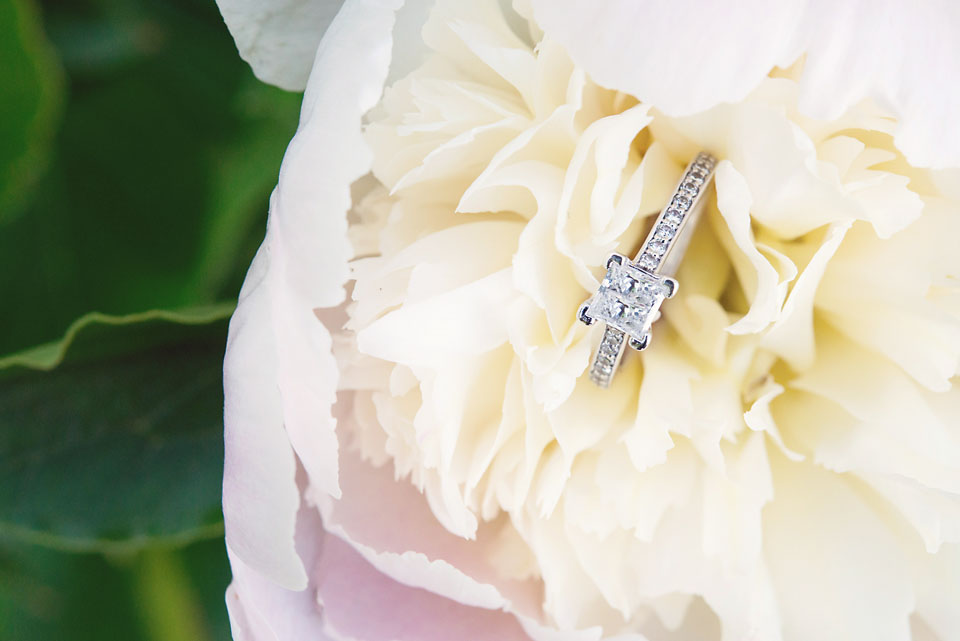 Engagement ring on pink and white peony flower