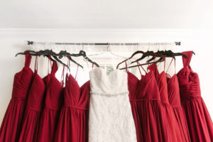 white wedding gown and red bridesmaid dresses