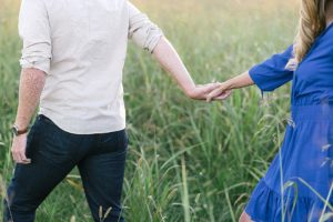 Tall grass holding hands engagement photo session
