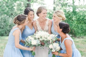 bridesmaids white flowers blue dresses