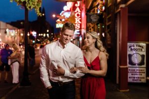 couple walking on Broadway in downtown Nashville