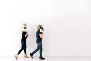 Florists carrying flowers against a blank wall
