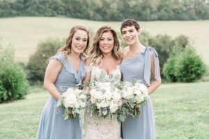 bridesmaids blue gray dresses white flowers