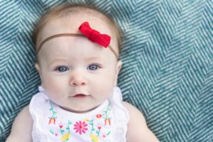 baby outdoor portrait red bow